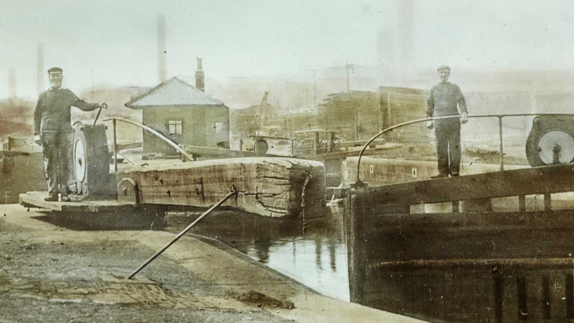Picture of two men standing on a canal lock.